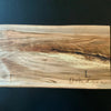 Maple live edge cutting board engraved on the bottom right corner with customers first initial and surname