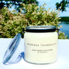 20oz glass jar candle with metal black handle. Clear Fragrance label with black Muskoka Tranquility fragrance