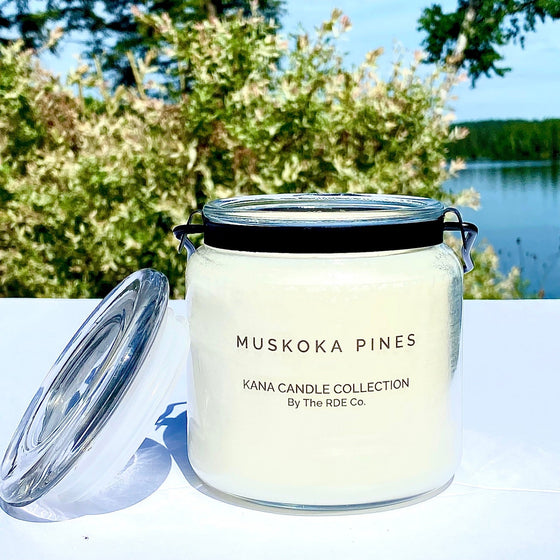 20oz glass jar candle with metal black handle. Clear Fragrance label with black Muskoka Pines fragrance