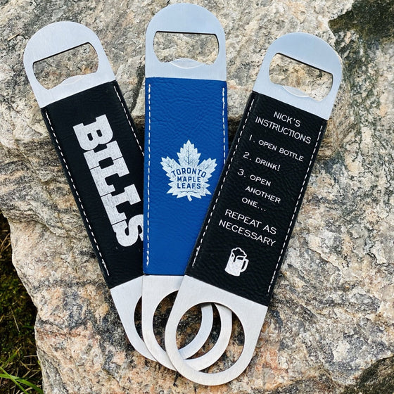 3 Leatherette Bottle Openers with sports team engraved on the front. 1 Blue, 2 Black - The Red Door Engraving Company Inc.